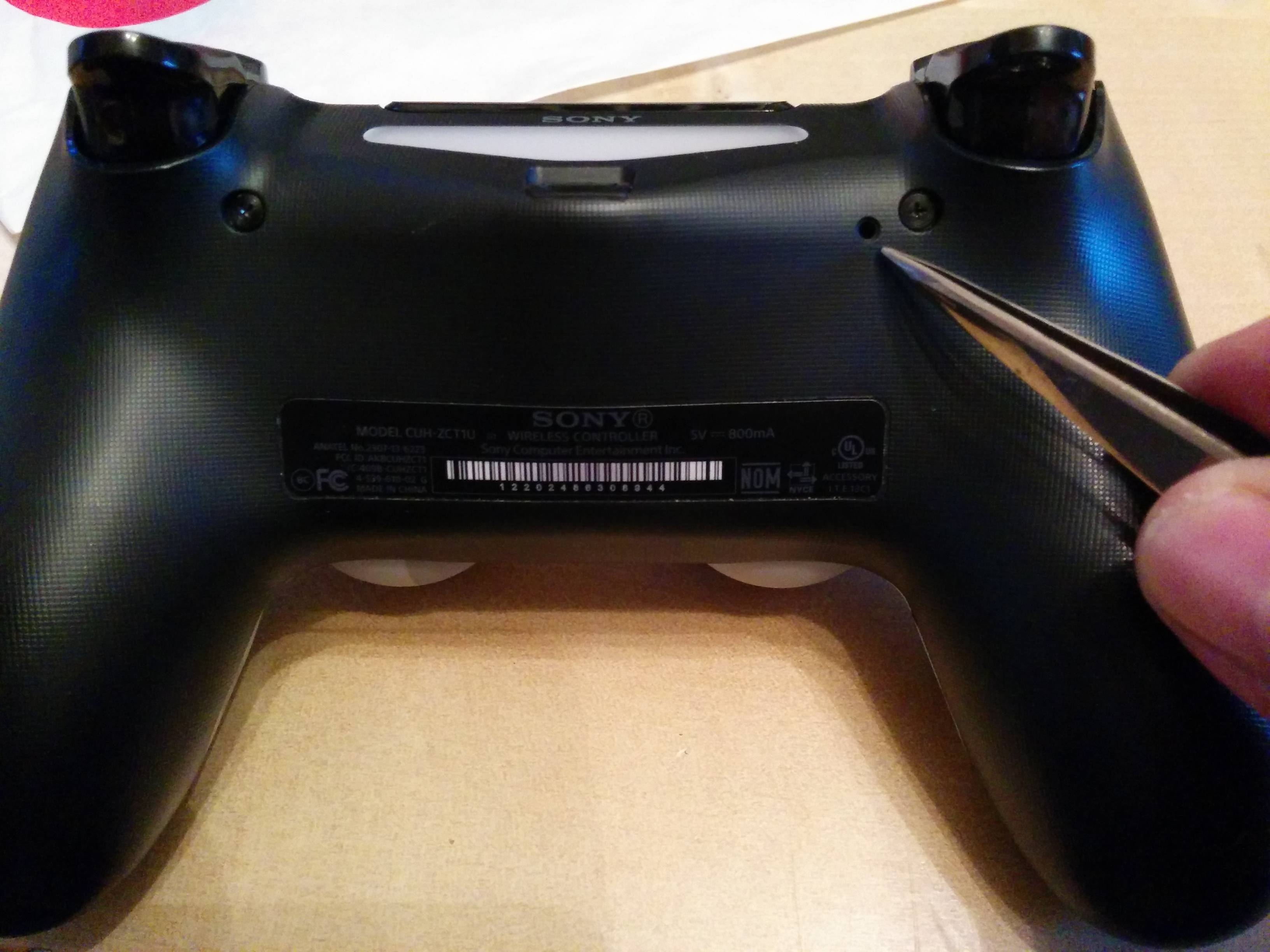 Locate the small reset button on the back of the controller.
Use a paperclip or similar object to press and hold the reset button for a few seconds.